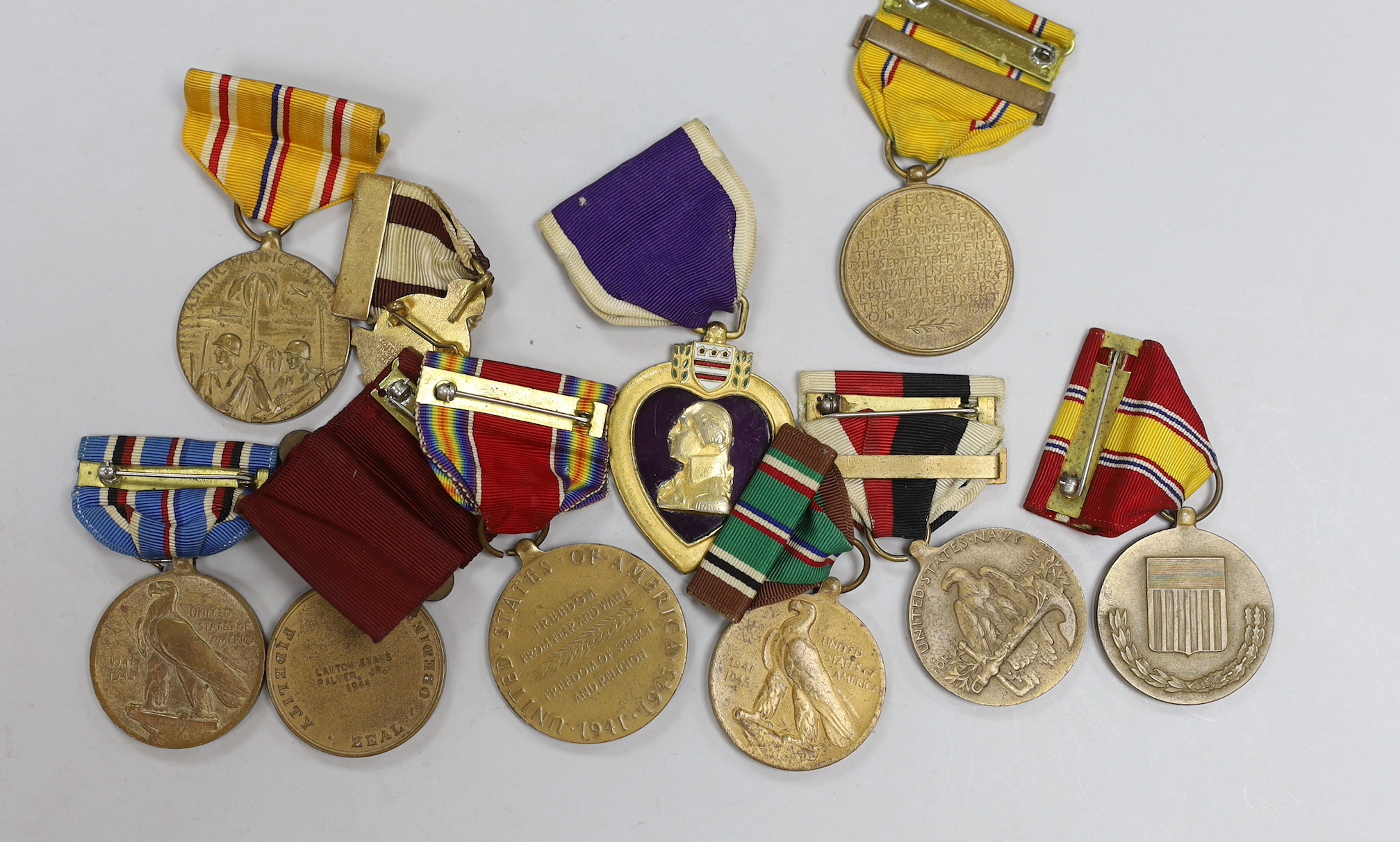 A collection of American WWII medals, including a Purple Heart, unnamed